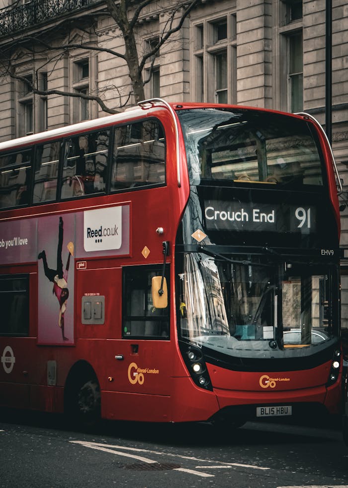 Classic red double-decker bus on London street showcasing Crouch End route number 91.